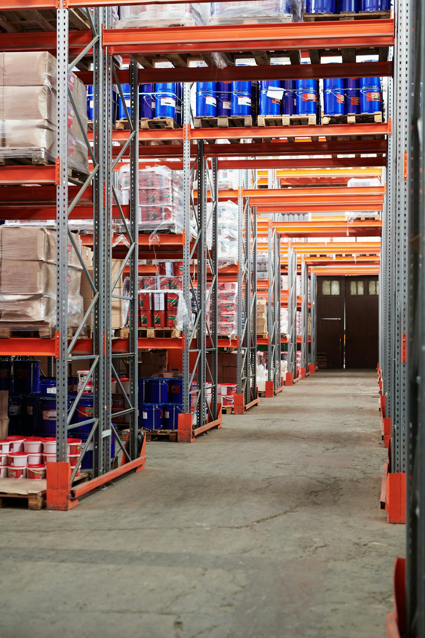 Home Industrial warehouse interior with organized shelves stacked with packages and goods.
